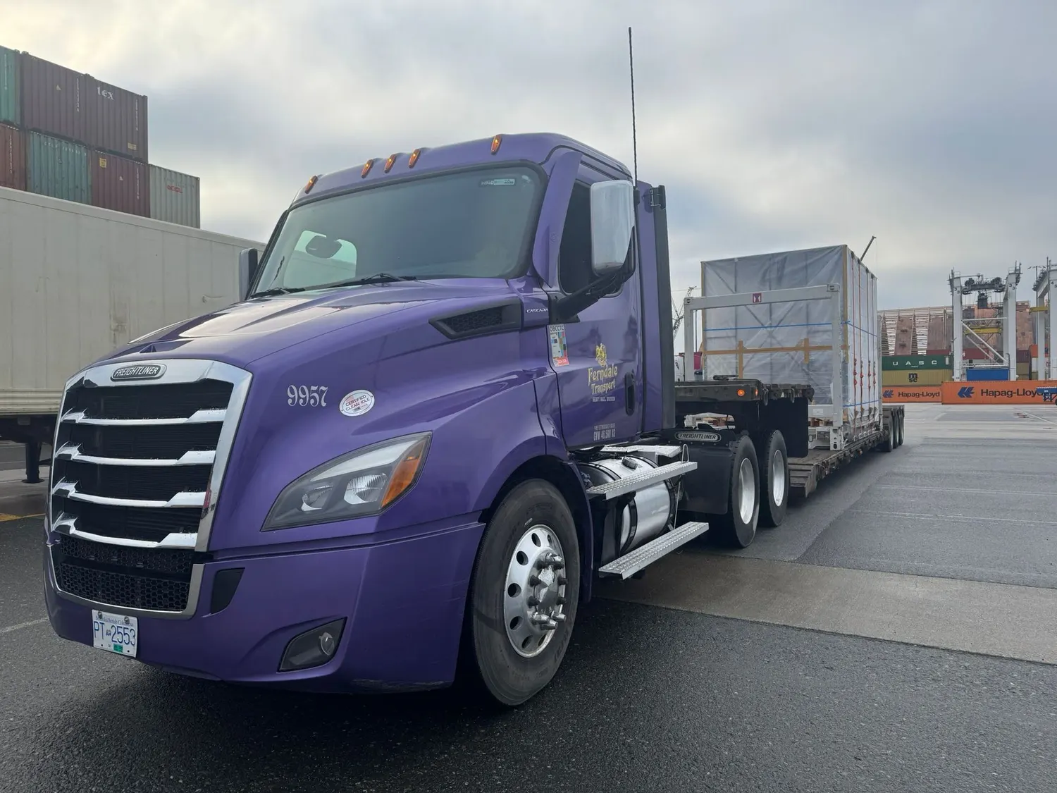 Ferndale Transport purple truck at a container terminal